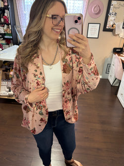 A soft, flowy dolman sleeve cardigan with a delicate floral pattern, draped over a model. The lightweight fabric gives it an airy, relaxed fit, making it a versatile layering piece. Designed to fit sizes 2 to 16, this cardigan features a flattering silhouette with an open front. Perfect for casual or dressy outfits, the breathable material ensures comfort in all seasons.